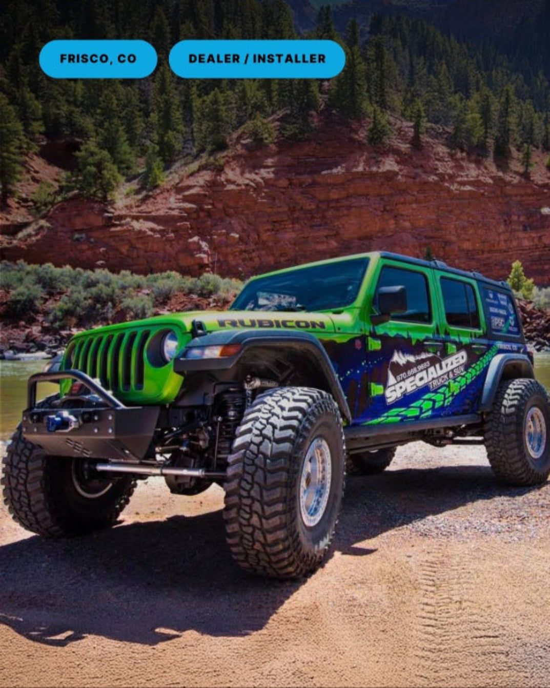 Green Jeep Wrangler on a dirt road with mountains in the background