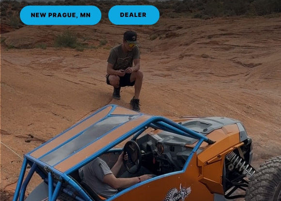 Off-road vehicle on a rocky terrain with a person inside, in New Prague, MN.